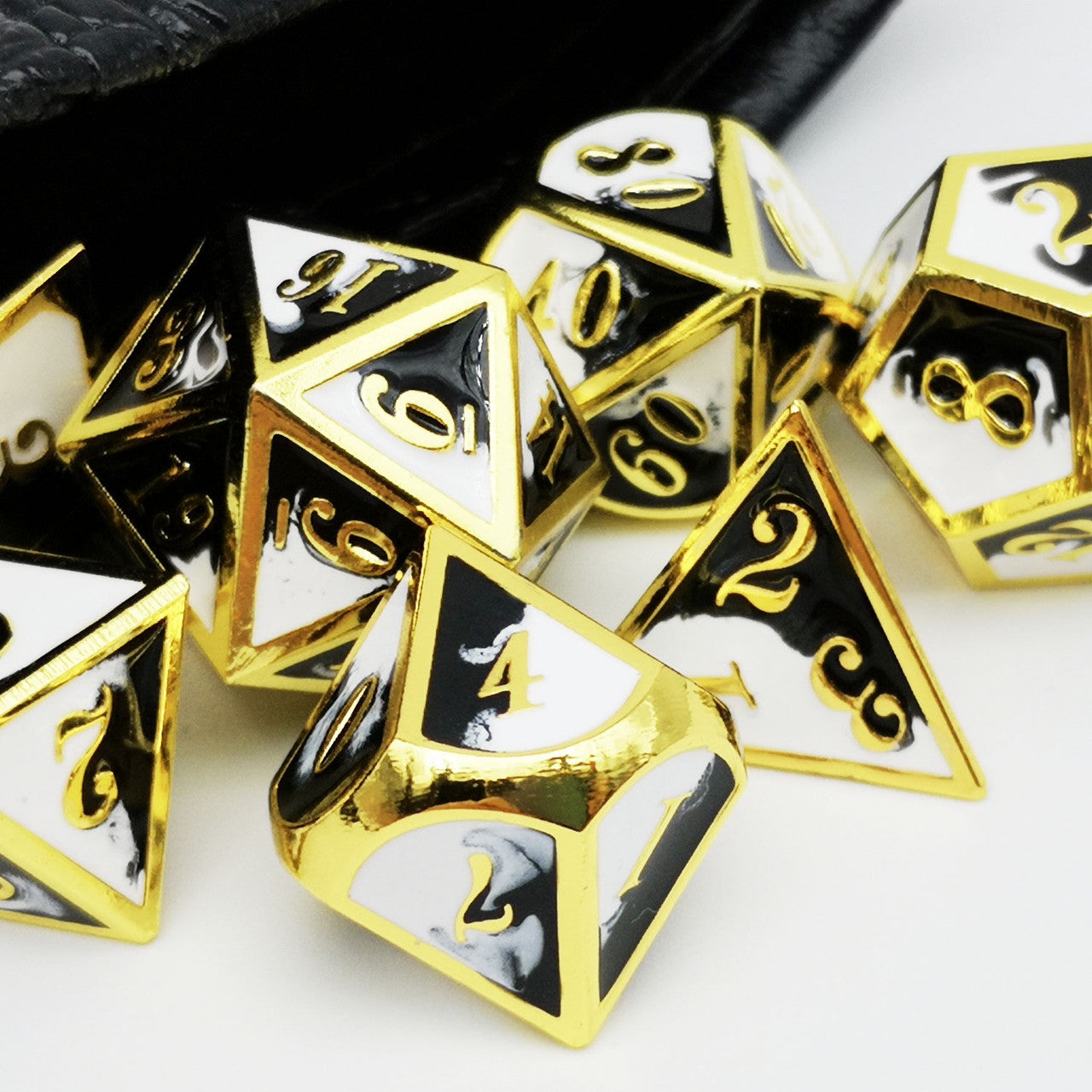 gold metal dice, black white dice, black dice, white dice
