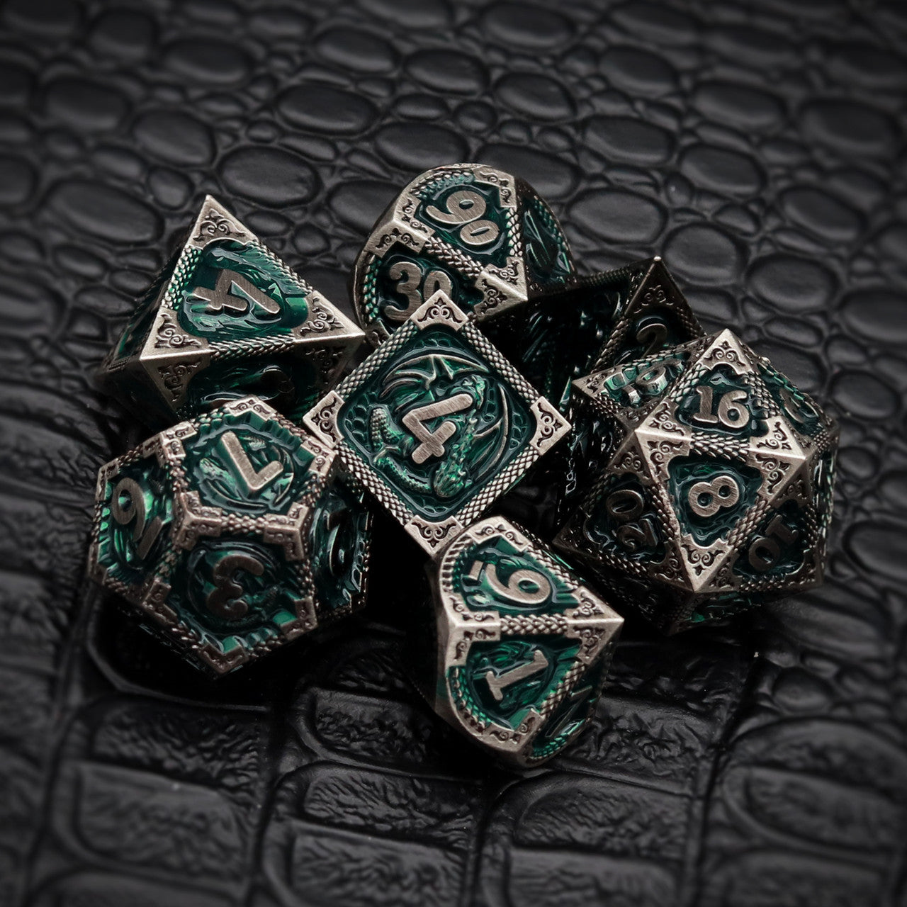 green metal dnd dice set with dragon pattern and dragon skin leather dice bag