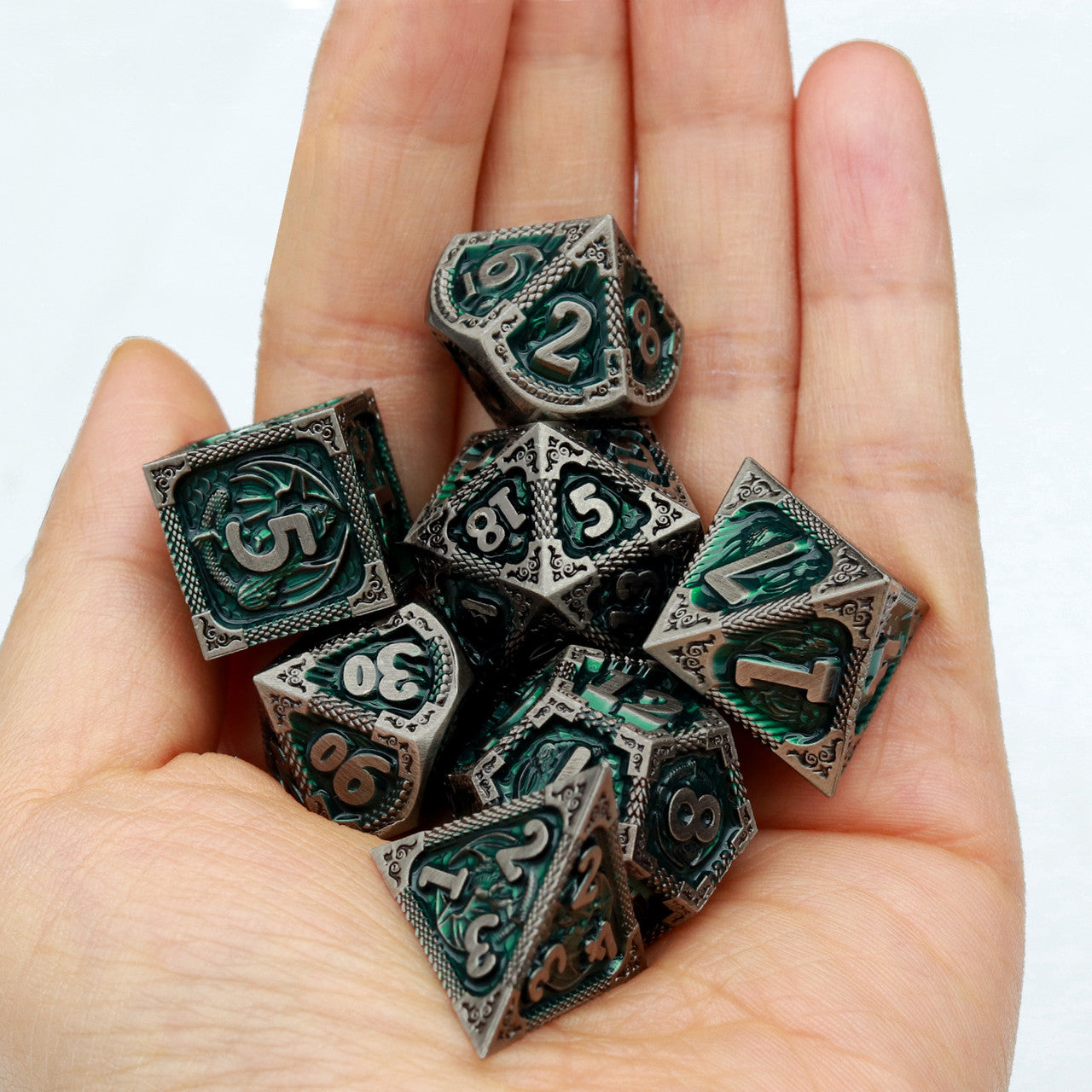 green metal dnd dice set with dragon pattern and dragon skin leather dice bag